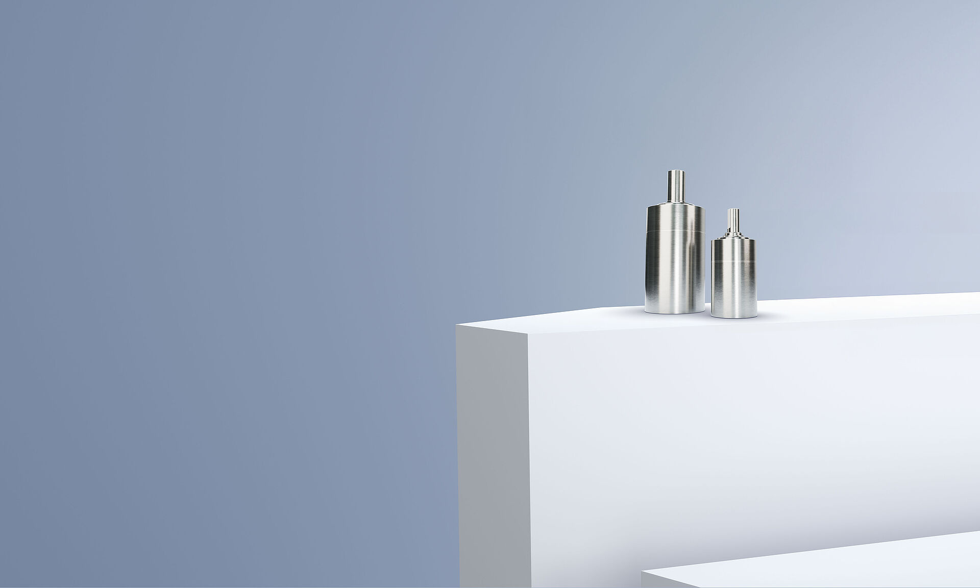 Two planetary gearheads from the FAULHABER GPT LN family arranged on white steps in front of a gray-blue background.